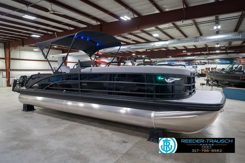 Slide: The Image of 2026 Bennington 26 MSB pontoon boat in showroom with canopy and sleek design. - 5