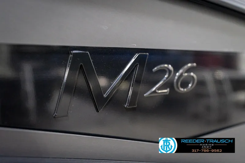 Slide: The Image of 2026 Bennington 26 MSB logo on sleek black surface, Reeder-Trausch Marine contact details. - 51