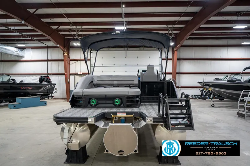 Slide: The Image of 2026 Bennington 26 MSB pontoon boat in a spacious indoor showroom. - 8