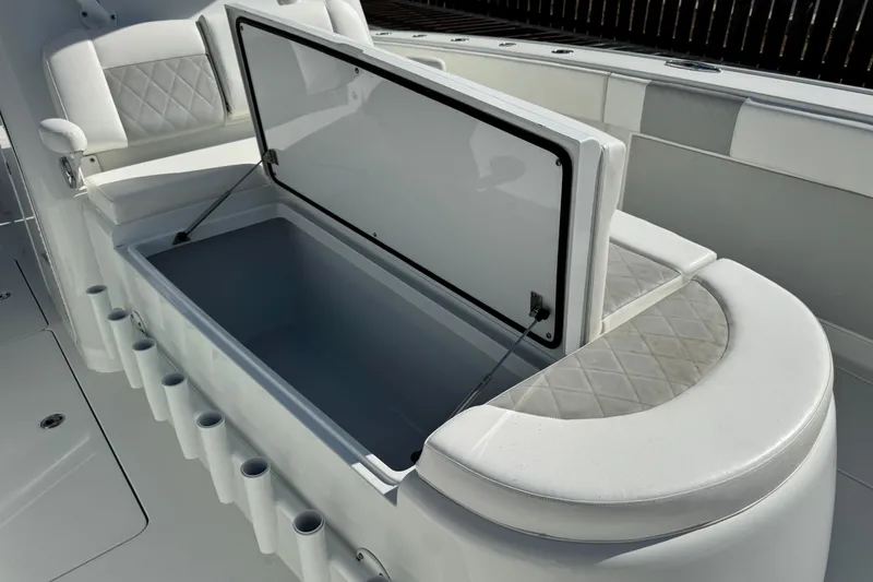Slide: The Image of Open storage compartment on 2018 Freeman 42 LR boat with cushioned seating. - 13