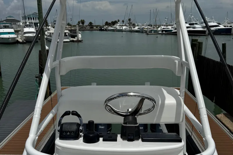 Slide: The Image of Helm of 2018 Freeman 42 boat docked at marina with steering wheel and controls. - 16