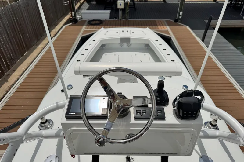 Slide: The Image of Helm of 2018 Freeman 42 boat with steering wheel and controls, docked at marina. - 17