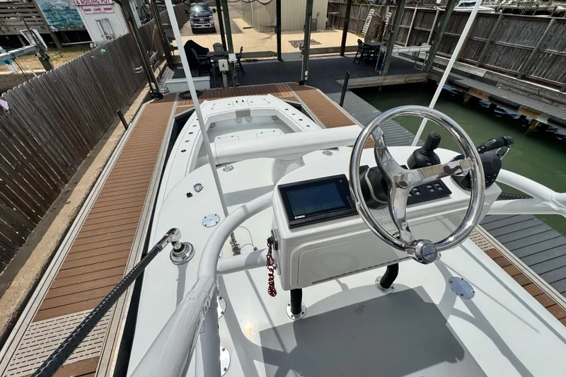 Slide: The Image of 2018 Freeman 42 boat docked, featuring steering wheel and control panel. - 18