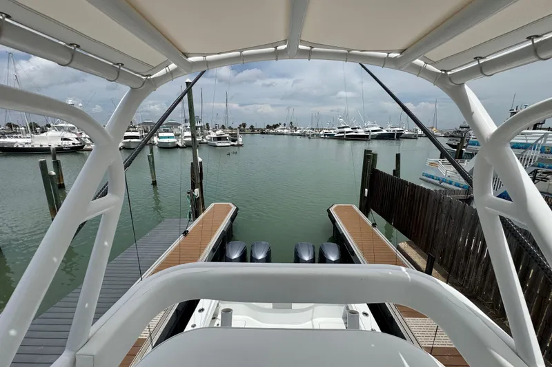 Slide: The Image of Freeman 42 boat docked at marina, showcasing sleek design and powerful engines, 2018 model. - 19