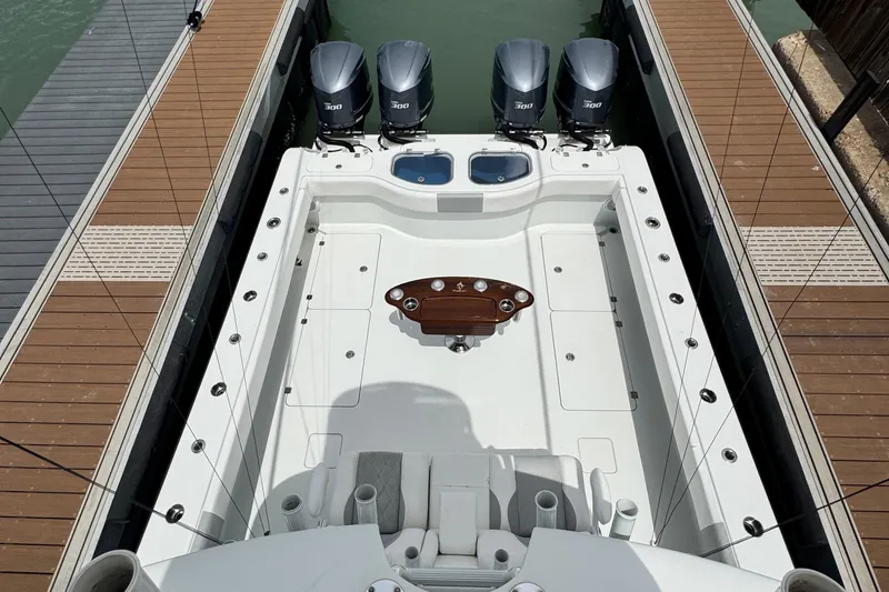 Slide: The Image of 2018 Freeman 42 boat with four engines docked, featuring spacious deck and fishing setup. - 20
