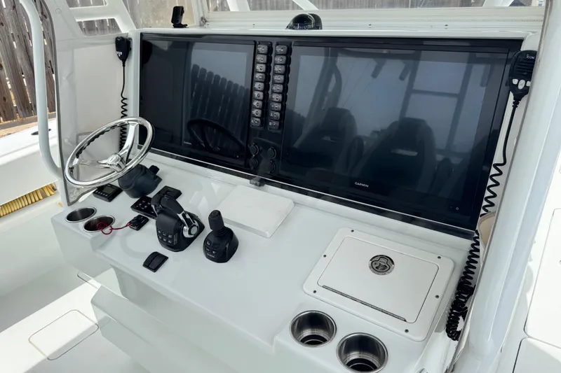 Slide: The Image of Control panel of a 2018 Freeman 42 boat with steering wheel and navigation screens. - 21