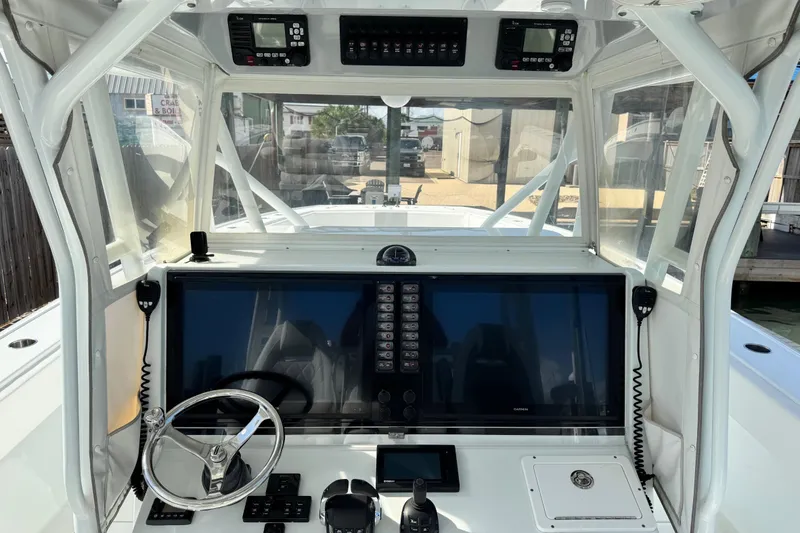 Slide: The Image of Helm of 2018 Freeman 42 LR boat with advanced navigation controls and steering wheel. - 22