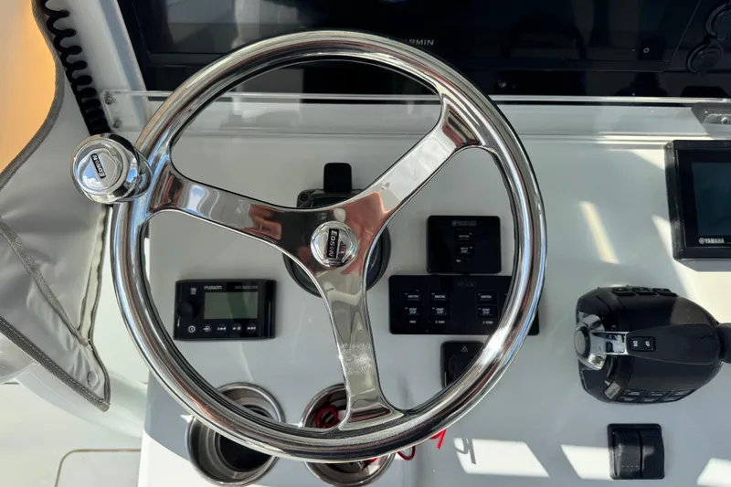 Slide: The Image of Steering wheel and controls of a 2018 Freeman 42 LR boat cockpit. - 23