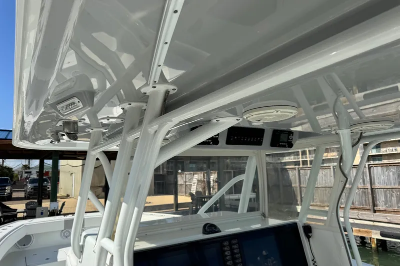 Slide: The Image of 2018 Freeman 42 LR boat console with advanced navigation equipment and sturdy T-top structure. - 25