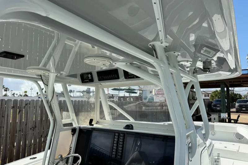 Slide: The Image of 2018 Freeman 42 LR boat console with advanced navigation equipment and sturdy T-top structure. - 27