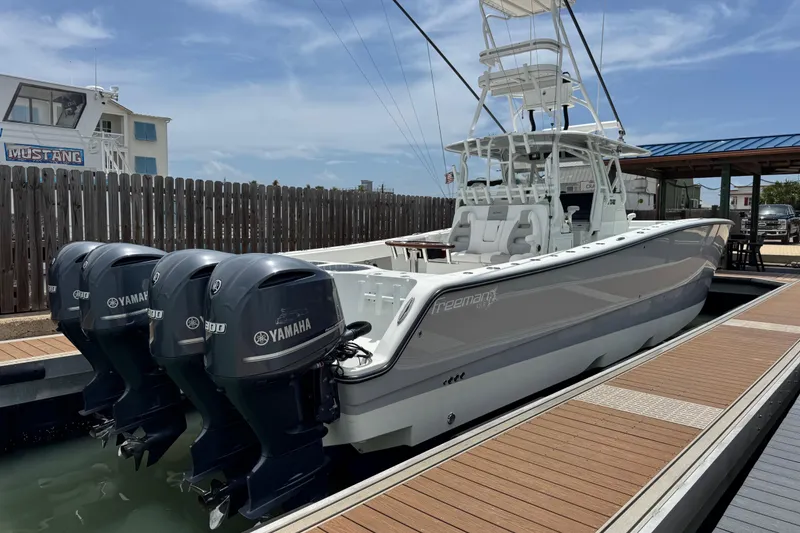 Slide: The Image of 2018 Freeman 42 boat with Yamaha engines docked under clear sky. - 3