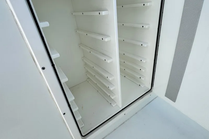 Slide: The Image of Open storage compartment with vertical slots in a 2018 Freeman 42 LR boat. - 33
