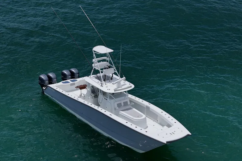 Slide: The Image of 2018 Freeman 42 boat on clear blue water, featuring multiple outboard engines. - 6