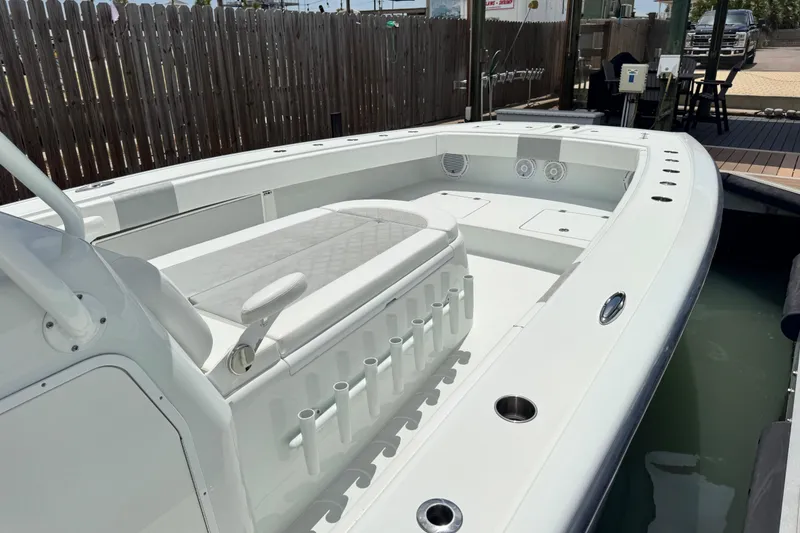 Slide: The Image of 2018 Freeman 42 boat with spacious deck and seating, docked near wooden fence. - 9