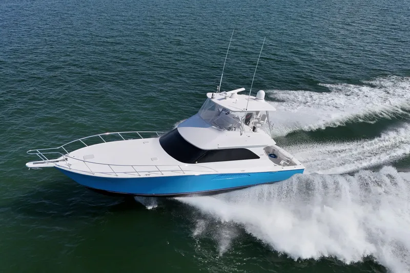 The Image of 2003 Viking 48 Convertible yacht cruising on open water, creating a wake. - 0