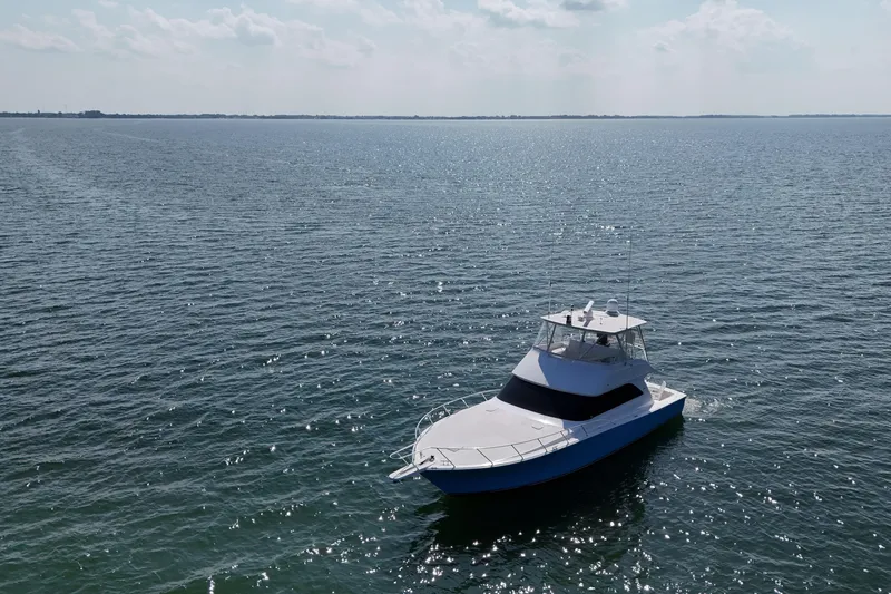 Slide: The Image of 2003 Viking 48 Convertible yacht interior with open storage drawers and cabinets. - 10