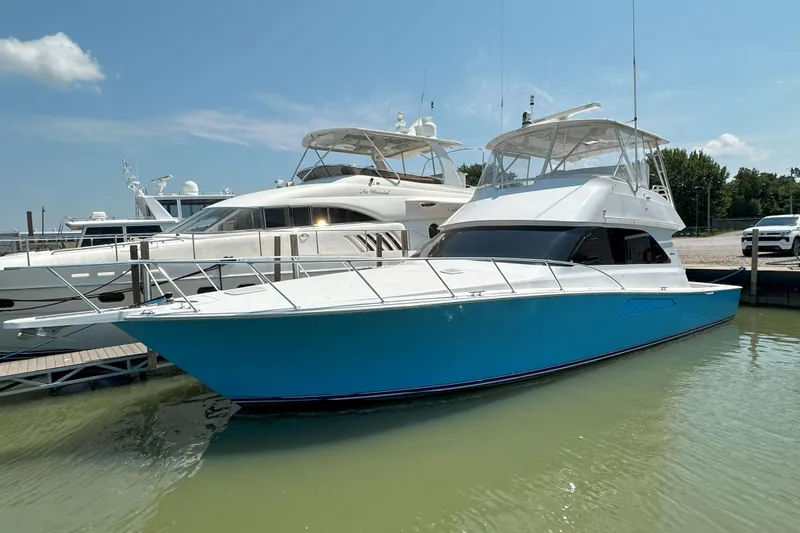 Slide: The Image of Engine room entrance of 2003 Viking 48 Convertible yacht, showcasing clean, white interior. - 13