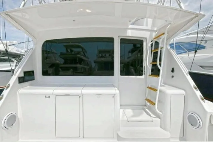 Slide: The Image of Luxurious interior of a 2003 Viking 48 Convertible yacht with elegant wood finishes. - 17