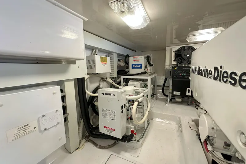 Slide: The Image of Narrow hallway inside 2003 Viking 48 Convertible yacht, featuring elegant wood finishes and soft lighting. - 23