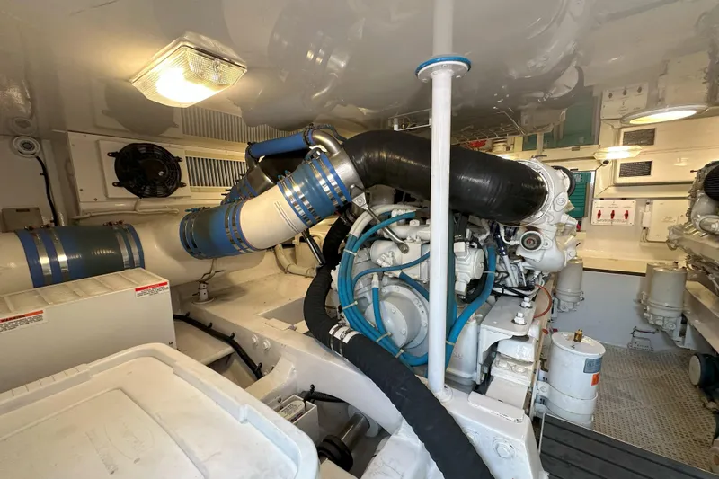 Slide: The Image of Bunk beds in 2003 Viking 48 Convertible yacht cabin, featuring cozy bedding and wooden finishes. - 24