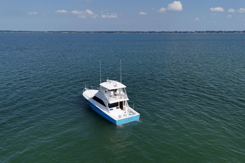 Slide: The Image of Luxurious cabin interior of 2003 Viking 48 Convertible yacht with cozy bedding and wooden cabinetry. - 3