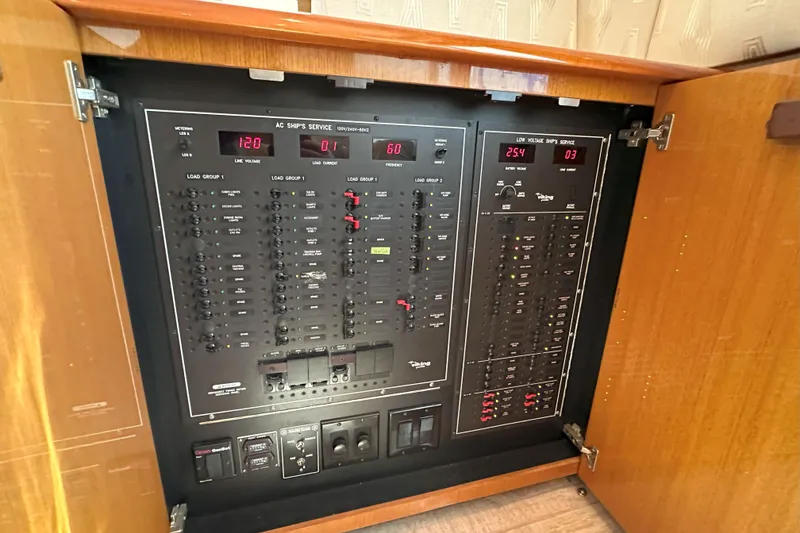 Slide: The Image of Control panel of a 2003 Viking 48 Convertible boat with navigation and communication equipment. - 32