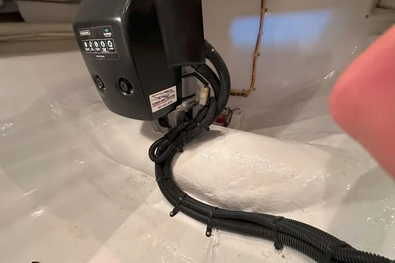 Slide: The Image of 2003 Viking 48 Convertible yacht on open water under clear sky. - 53