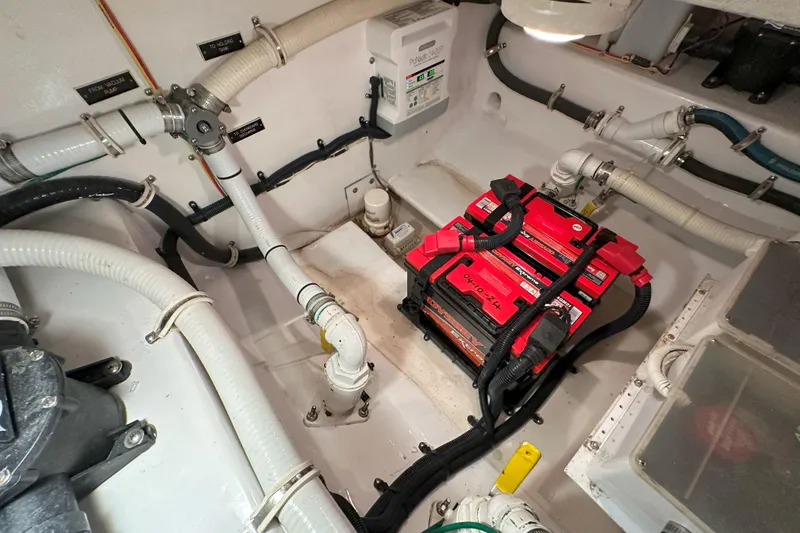 Slide: The Image of 2003 Viking 48 Convertible yacht on open water under clear blue sky. - 55