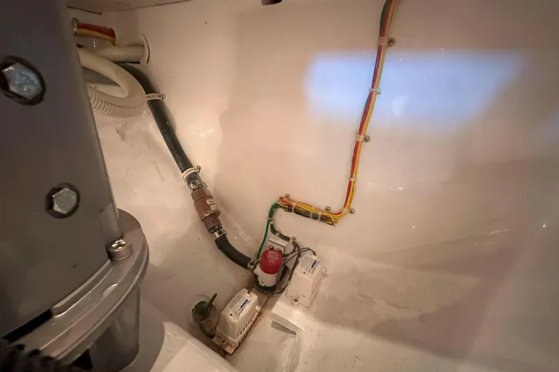 Slide: The Image of 2003 Viking 48 Convertible yacht on open sea under clear blue sky. - 56