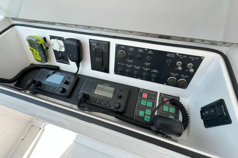 Slide: The Image of 2003 Viking 48 Convertible yacht cruising on open sea under clear sky. - 59