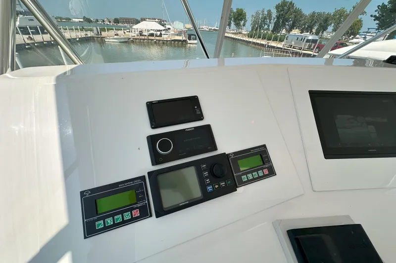 Slide: The Image of 2003 Viking 48 Convertible yacht on open sea under clear sky. - 60