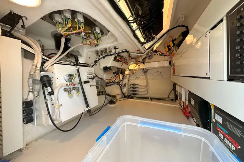 Slide: The Image of 2003 Viking 48 Convertible yacht on open water under clear sky. - 62