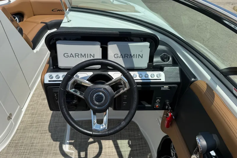 Slide: The Image of 2024 Crownline Eclipse E235 boat dashboard with Garmin navigation displays. - 8