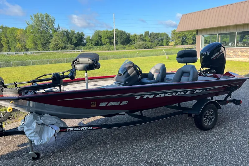The Image of 2021 Tracker Pro Team 175 TXW Tournament Edition boat on trailer, parked outdoors. - 0