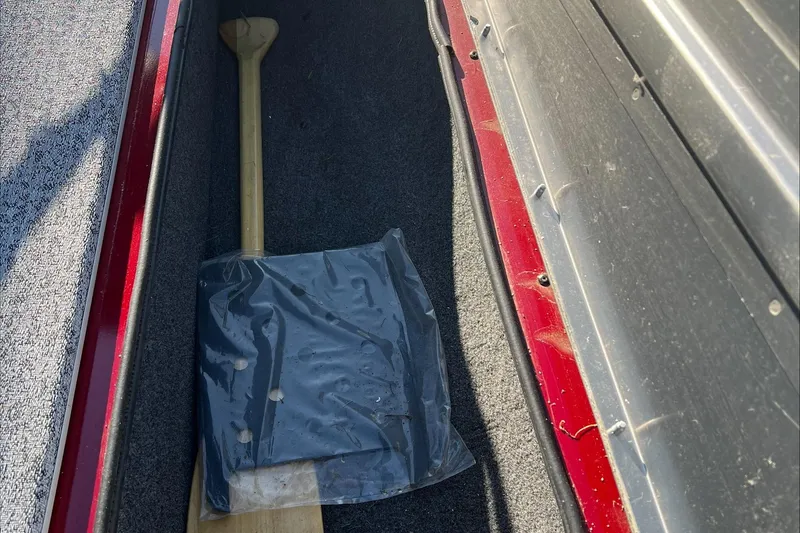 Slide: The Image of Storage compartment of 2021 Tracker Pro Team 175 TXW with paddle and cover. - 11