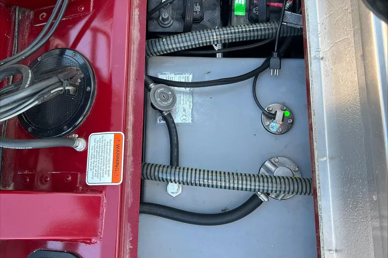 Slide: The Image of 2021 Tracker Pro Team 175 TXW Tournament Edition boat wiring and battery compartment. - 17