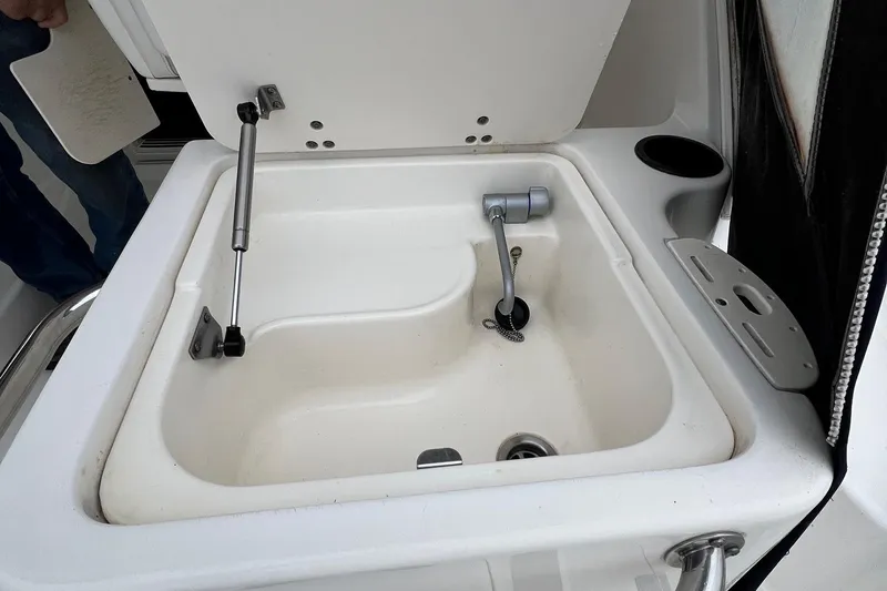 Slide: The Image of Boston Whaler 305 Conquest 2005 boat sink with open lid and faucet. - 11
