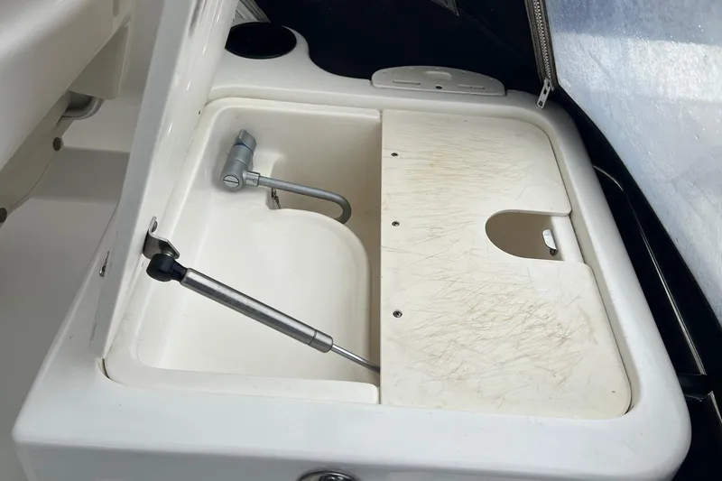 Slide: The Image of 2005 Boston Whaler 305 Conquest sink with cutting board and faucet. - 12
