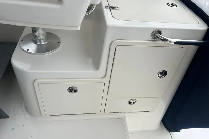 Slide: The Image of 2005 Boston Whaler 305 Conquest interior storage compartments and seating base. - 13