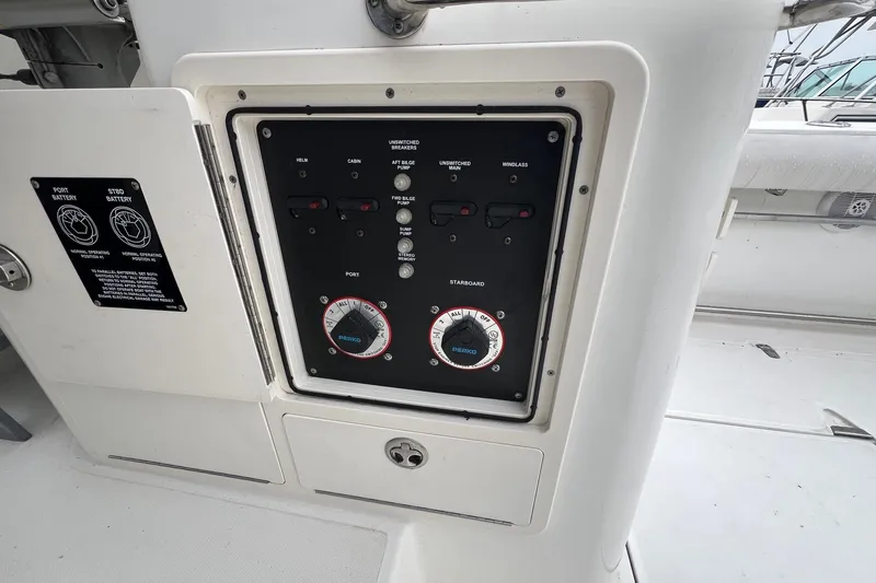 Slide: The Image of Control panel on a 2005 Boston Whaler 305 Conquest boat, featuring battery switches. - 14