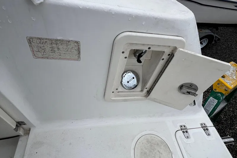 Slide: The Image of 2005 Boston Whaler 305 Conquest water access hatch with open door. - 16