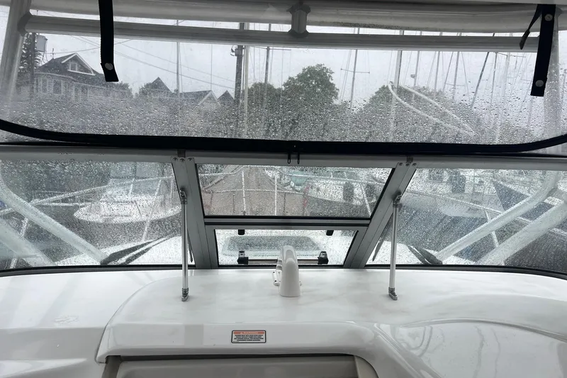 Slide: The Image of Rainy view from 2005 Boston Whaler 305 Conquest boat cockpit, marina in background. - 23