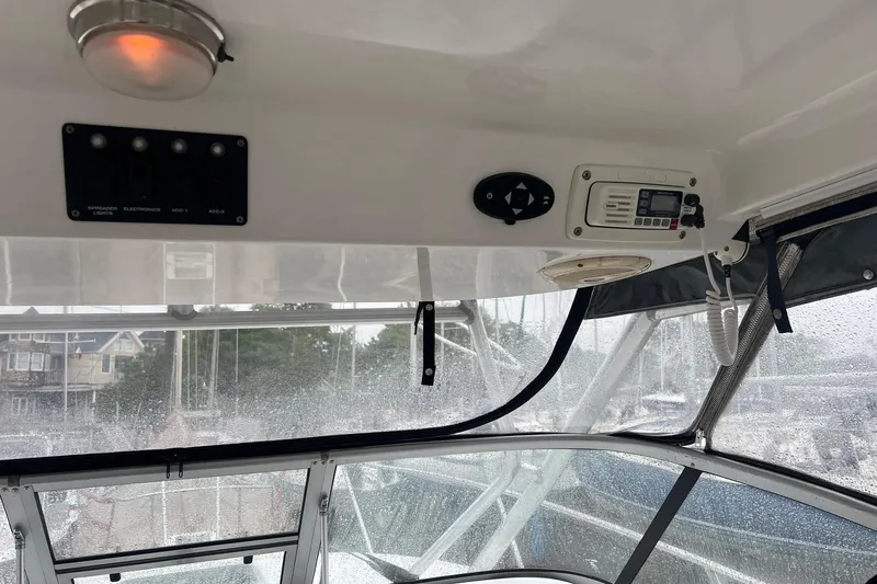 Slide: The Image of Interior view of a 2005 Boston Whaler 305 Conquest boat with control panel. - 27
