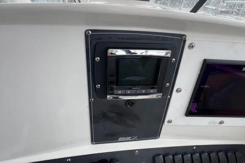 Slide: The Image of Dashboard of a 2005 Boston Whaler 305 Conquest boat with electronic controls. - 34