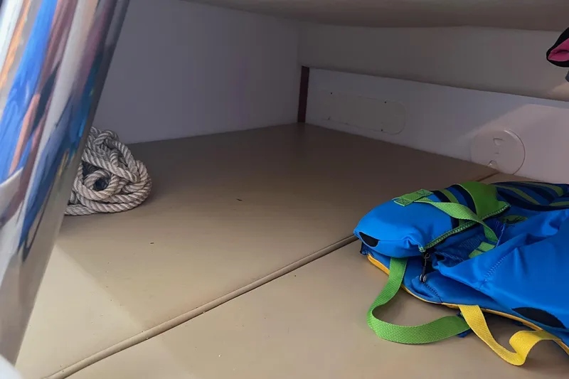 Slide: The Image of 2005 Boston Whaler 305 Conquest cabin with rope and blue life jacket. - 39