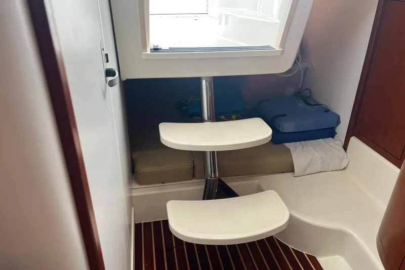 Slide: The Image of Interior cabin of 2005 Boston Whaler 305 Conquest with steps and seating area. - 45