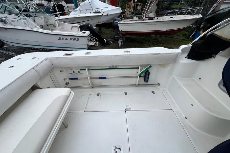Slide: The Image of 2005 Boston Whaler 305 Conquest boat deck with seating and storage compartments. - 7