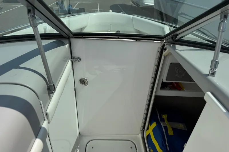Slide: The Image of 2001 Formula 280 Bowrider interior with white seating and blue accents, showcasing helm and dashboard. - 11