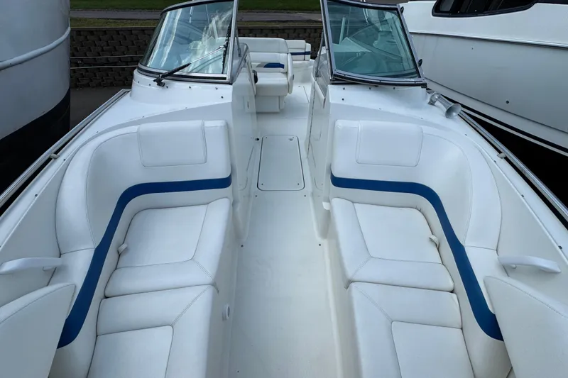 Slide: The Image of 2001 Formula 280 Bowrider boat in a marina parking lot, surrounded by other boats. - 14