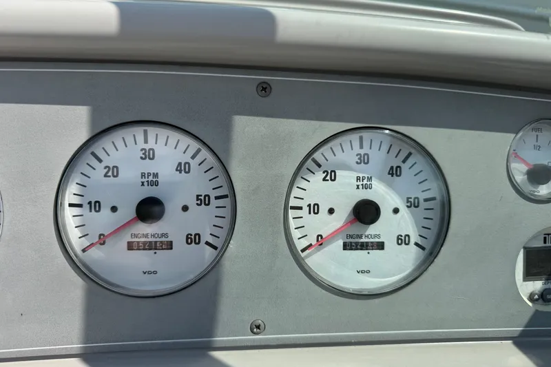 Slide: The Image of 2001 Formula 280 Bowrider boat interior with white and blue seating, docked outdoors. - 19